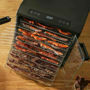 Excalibur 10 Tray Select dehydrator loaded with meat strips for making biltong or jerky.